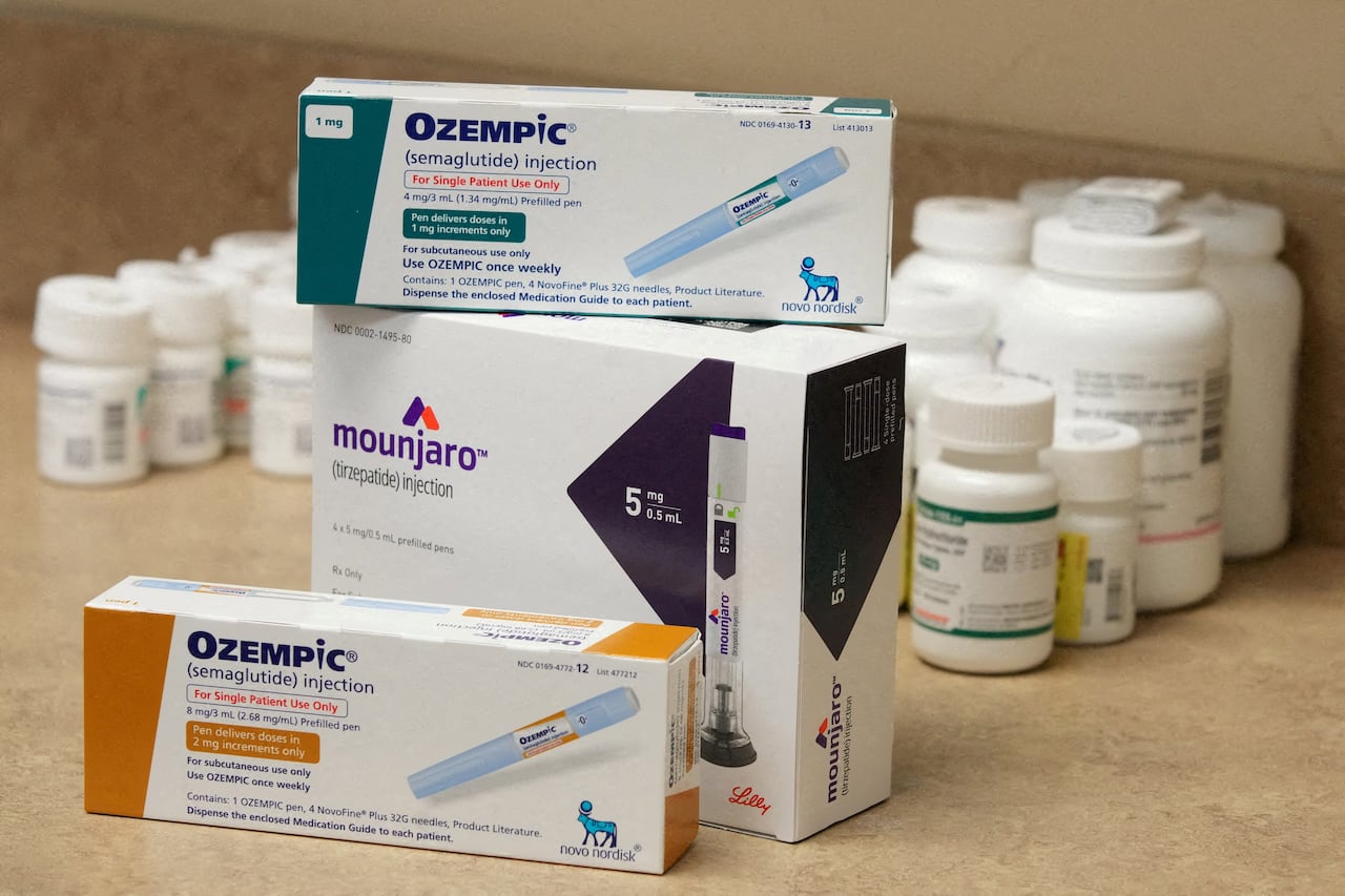 boxes of medication labelled ozzempic and mounjaro sit stacked on a counter