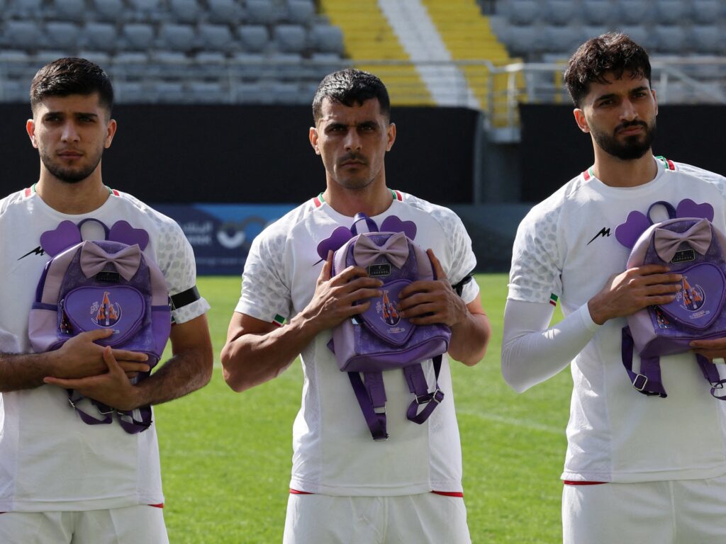 Iran footballers pay tribute to victims of school strike at start of war