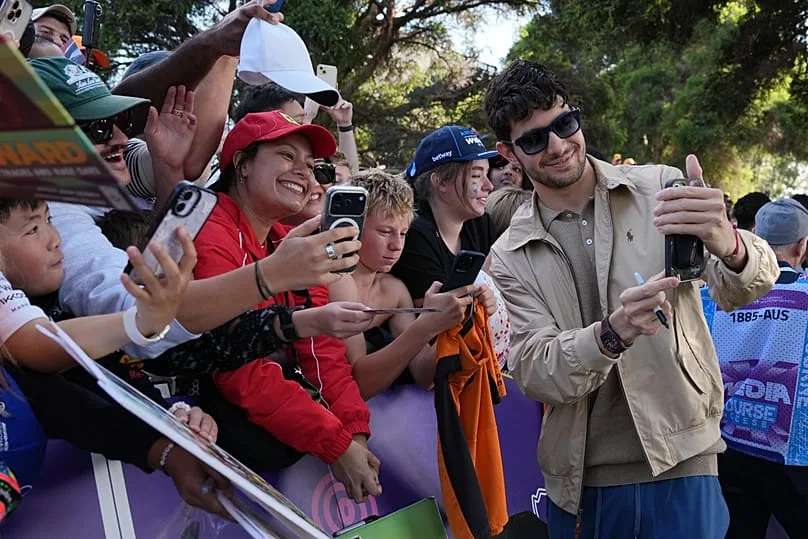 Haas driver Esteban Ocon poses with fans ahead of the Australian Grand Prix in Melbourne, Australia, 2026.