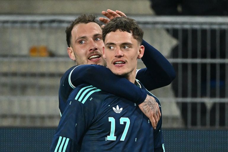 Germany's midfielder #17 Florian Wirtz celebrates scoring his team's third goal with Germany's defender #22 David Raum during the international friendly football match between Switzerland and Germany at St. Jakob-Park in Basel, Switzerland on March 27, 2026. (Photo by Fabrice COFFRINI / AFP)