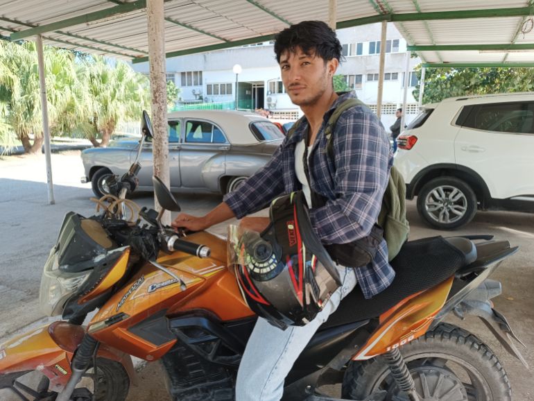 In Cuba, Alejandro Candelaria, who drives an electric motorcycle, has seen his income rise with the fuel shortage