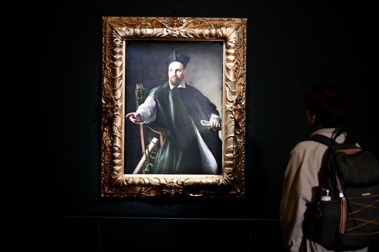 (FILES) A visitor looks at the private collection and never previously shown to the public painting "Portrait de Maffeo Barberini" by Italian master Caravaggio at the Gallerie Nazionali di Arte Antica in the Barberini palace in Rome on November 22, 2024.