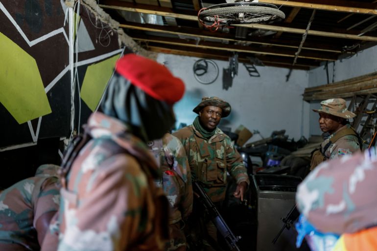South African National Defence Force (SANDF) soldiers search a building during a patrol operation in Riverlea, near Johannesburg, on March 11, 2026.