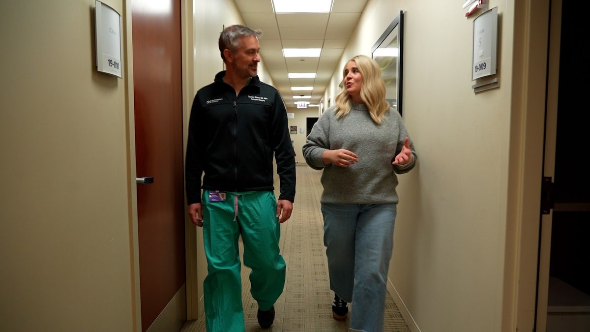 Amy Piccioli and doctor walk down hospital hallway