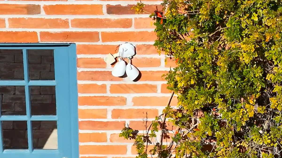 A floodlight that appears to be broken on the side of Nancy Guthrie's home