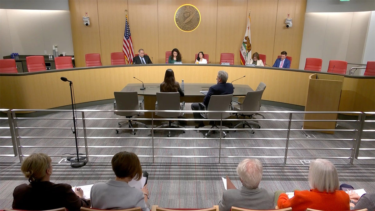 Members of the California Senate Budget Subcommittee on Education seated at a curved wooden dais.