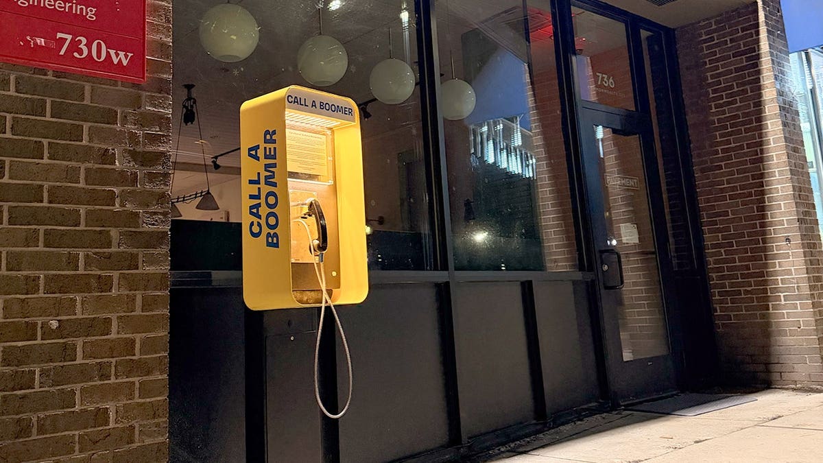 Call a Boomer payphone outside the coffee shop, it is bright yellow.