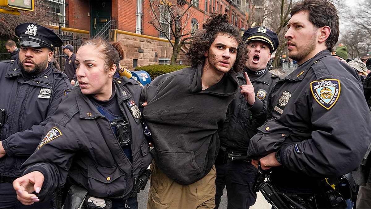 Police detain a man on a New York City street after he allegedly threw an explosive device during a protest.