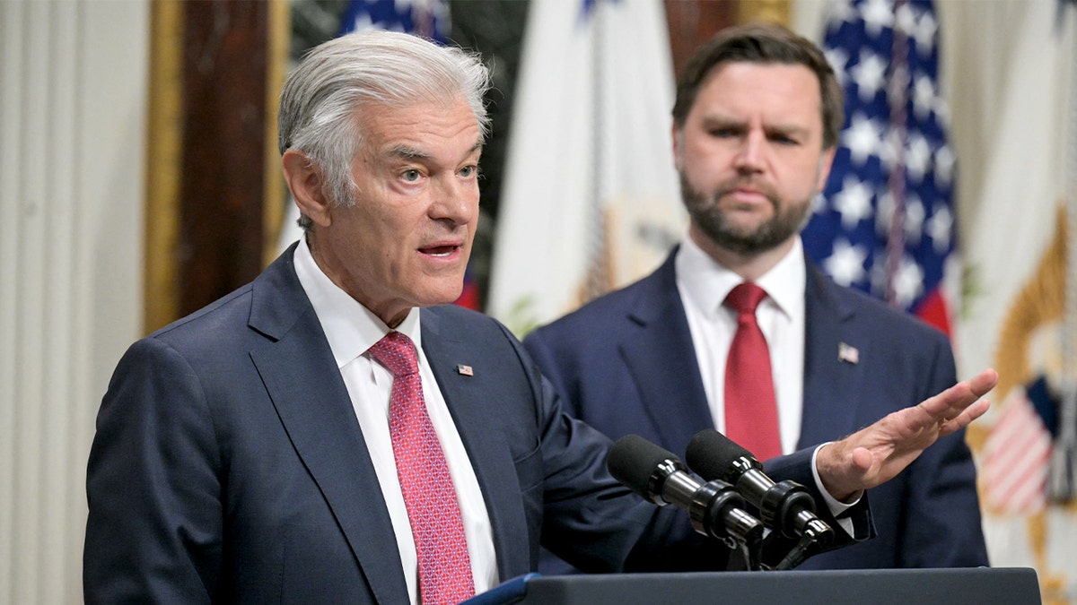 Vice President JD Vance stands beside Medicare and Medicaid Administrator Mehmet Oz as Oz delivers remarks inside the Eisenhower Executive Office Building.