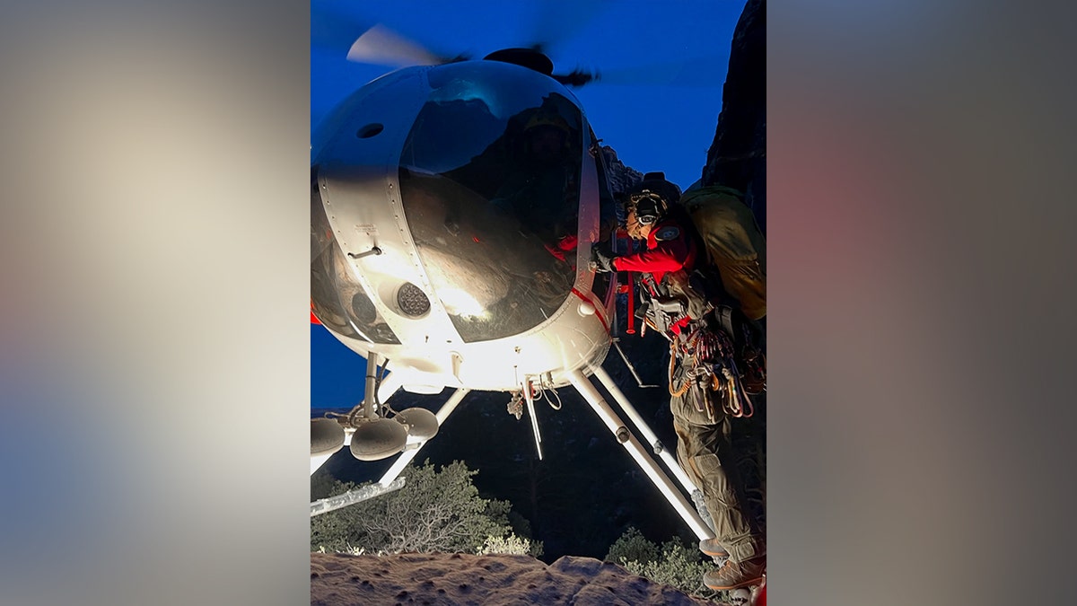Person walking up to a helicopter.