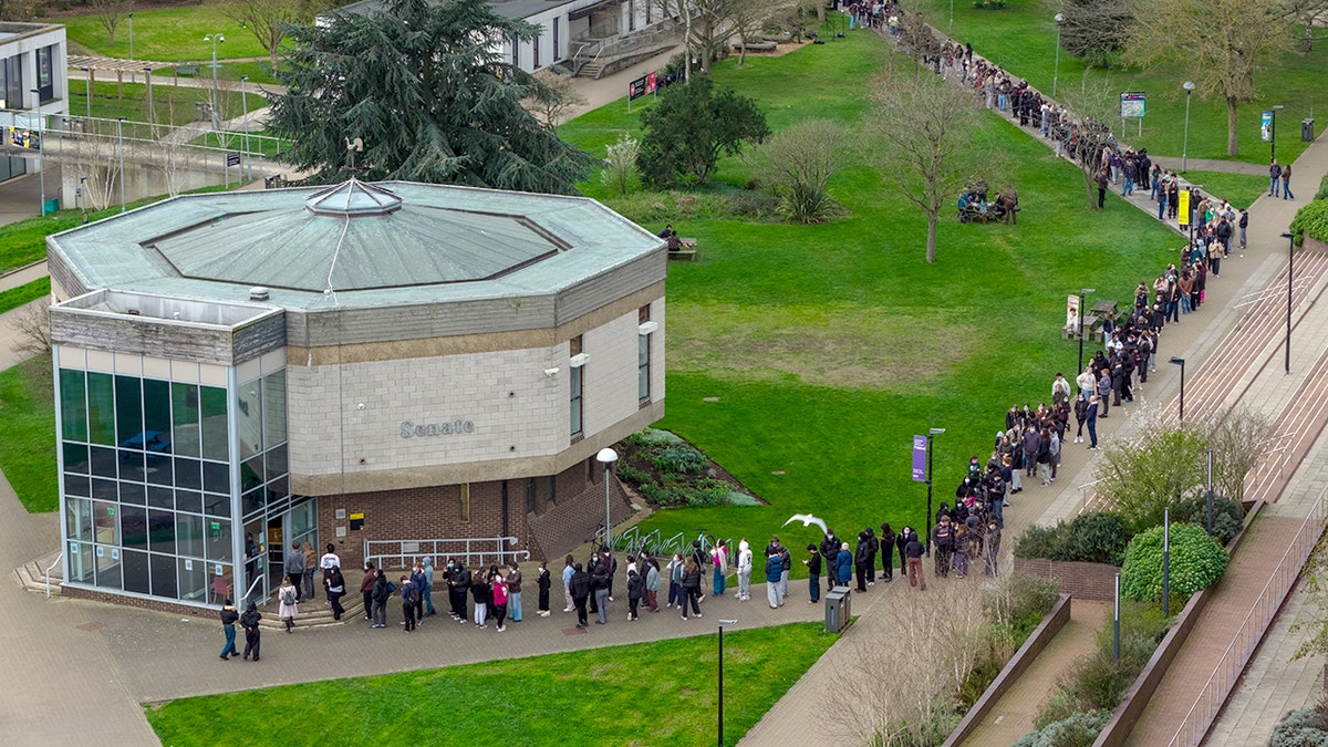 CANTERBURY, ENGLAND - MARCH 16: Staff and students, some wearing face masks, queue to receive antibiotics at the University of Kent in Canterbury after an outbreak of meningitis caused the deaths of two people, on March 16, 2026 in Canterbury, United Kingdom.