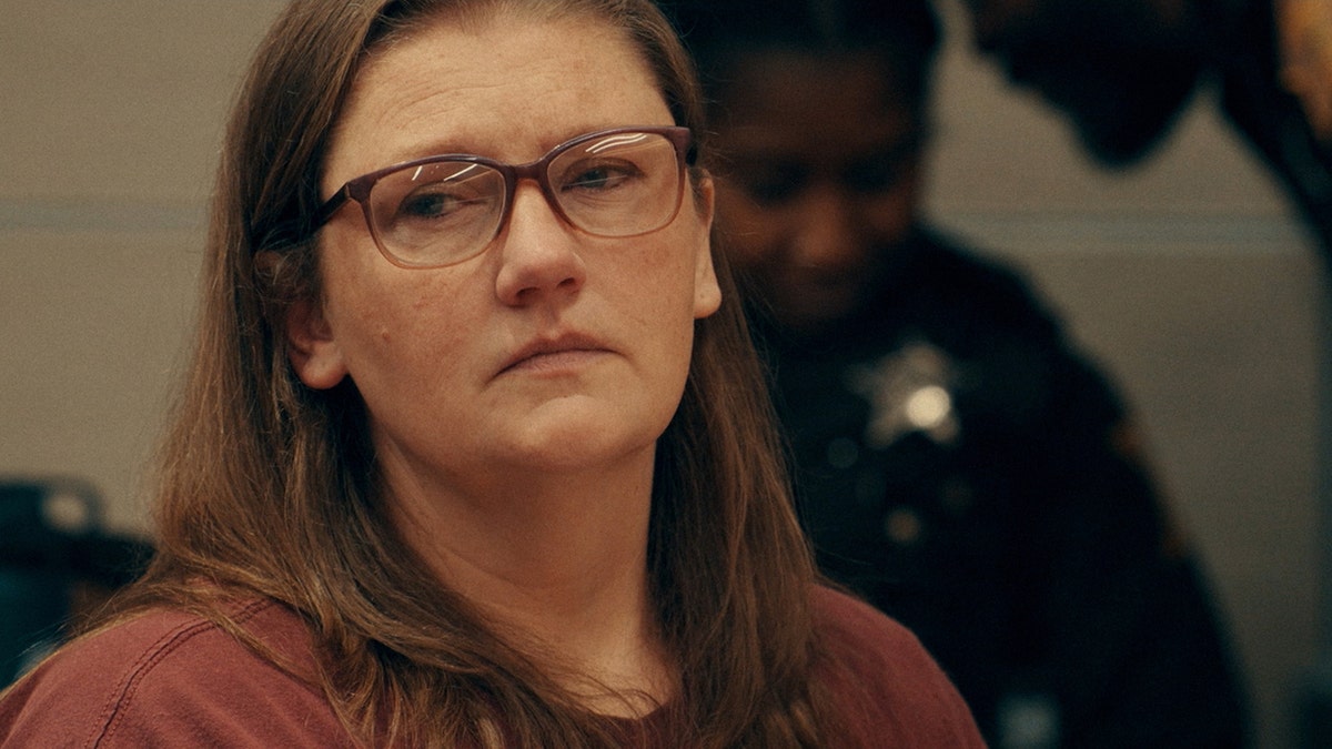 Sarah Pender wearing glasses looking away in court.