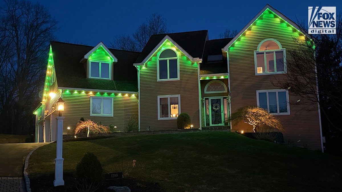 Sheridan Gorman is honored with green light bulb glowing on a porch of a residential home at night