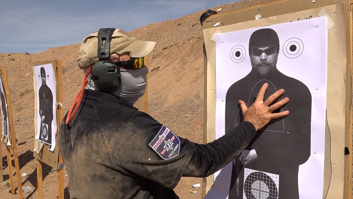 Magen Am leader Ian Turner demonstrates the proper areas to target when shooting.