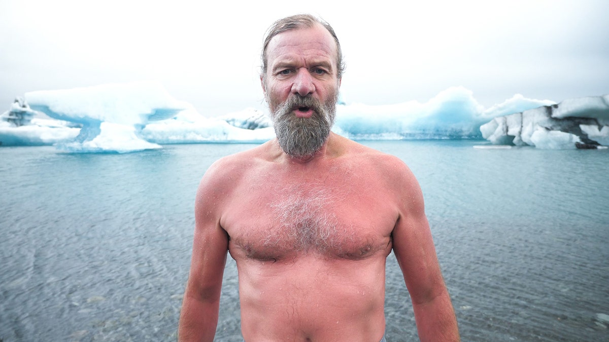 wim hof standing in front of icebergs