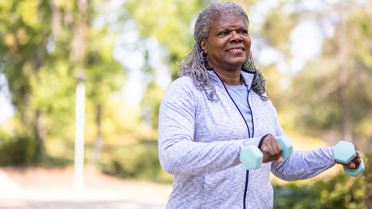 Senior black woman working out staying healthy outdoors.