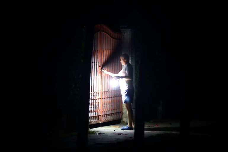 A person shines a flashlight during a power outage in Havana, Cuba