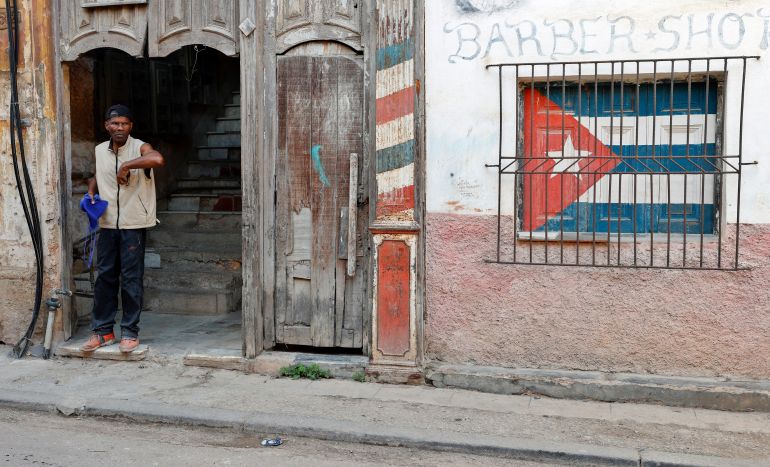 A person waits at the entrance to a house in Havana, Cuba, 25 March 2026.