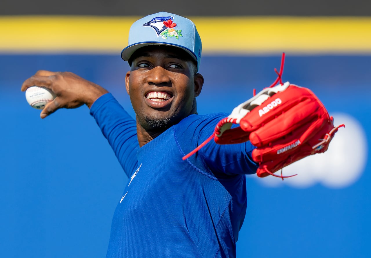 Blue Jays outfielder Jesús Sánchez in the middle of tossing a baseball during a spring training workout
