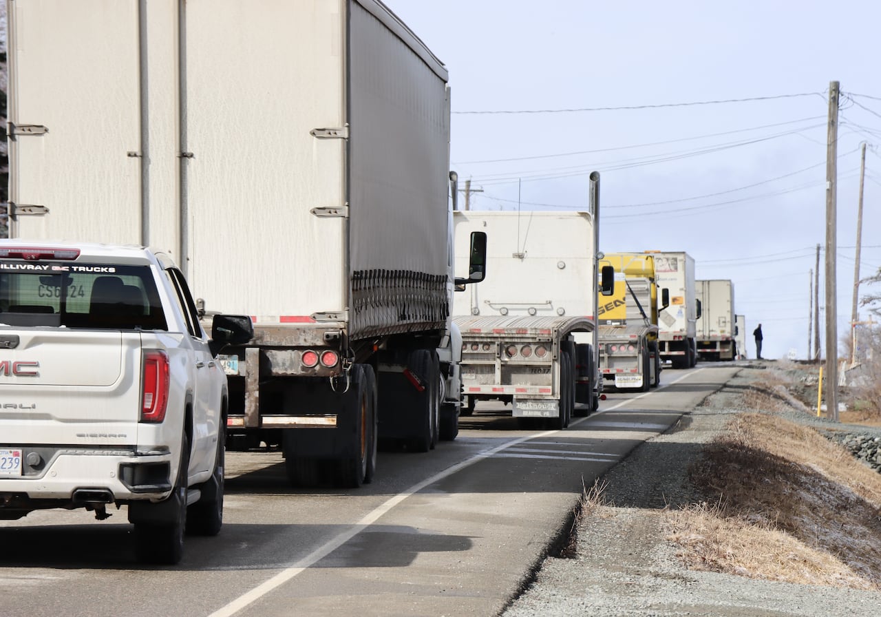 Vehicles are lined up on a highway.