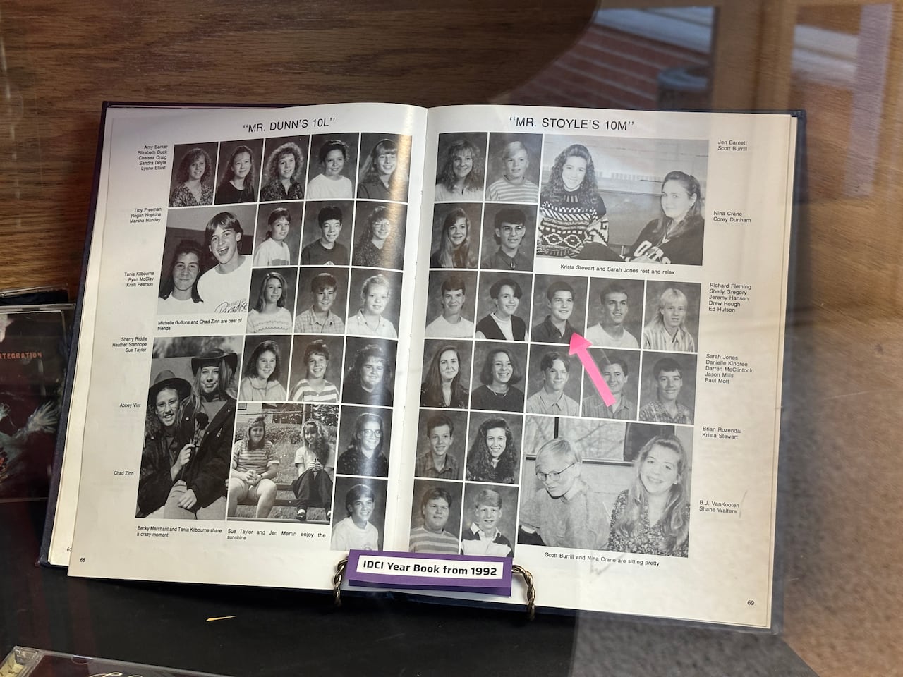 An open high school yearbook from 1992 showing black-and-white student portraits, with one photo of Jeremy Hansen marked by an arrow.