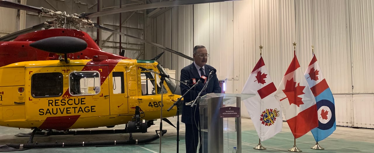 Man in suit at podium.