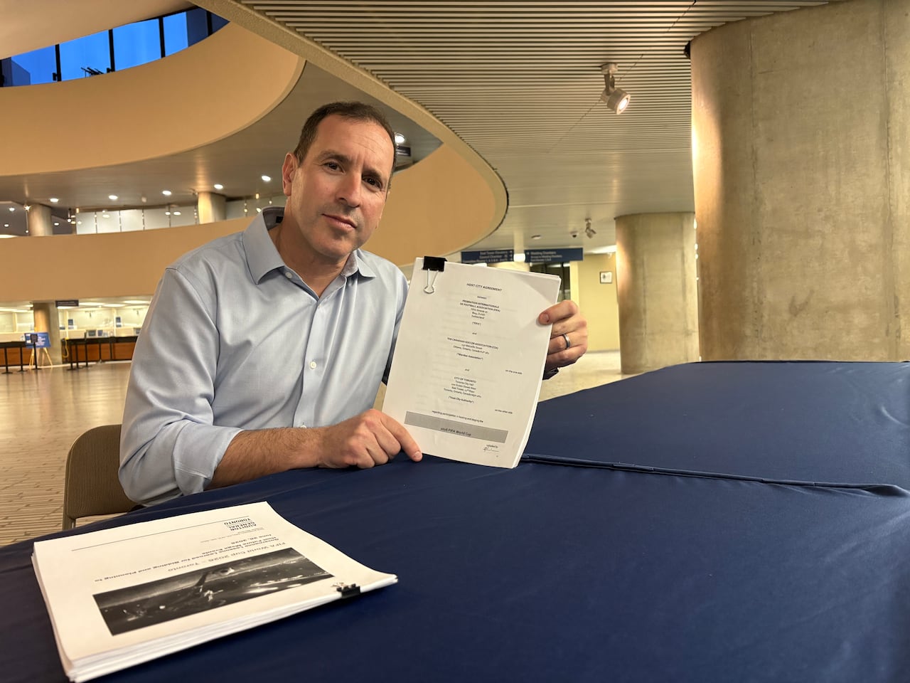 A person holding documents.