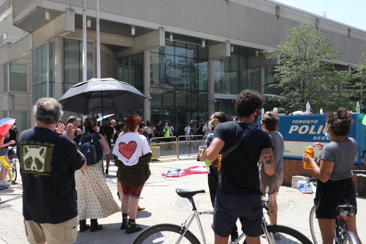 Supporters of Black Lives Matter Toronto are seen at a protest outside a police detachment in downtown Toronto on Saturday, July 18, 2020. Three protesters were arrested earlier in the day after demonstrators threw pink paint on several statues, incl