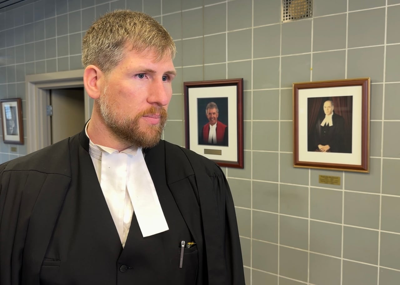 A man in lawyer robes is shown.