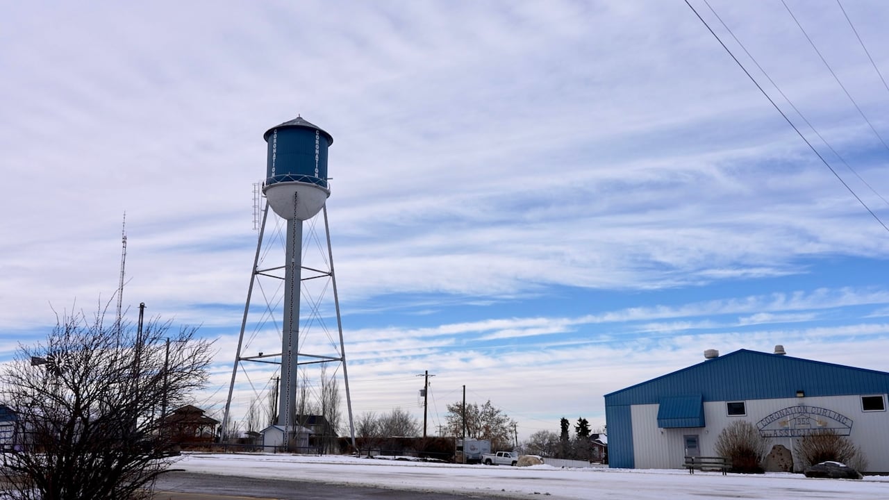 A water tower besides a structure.