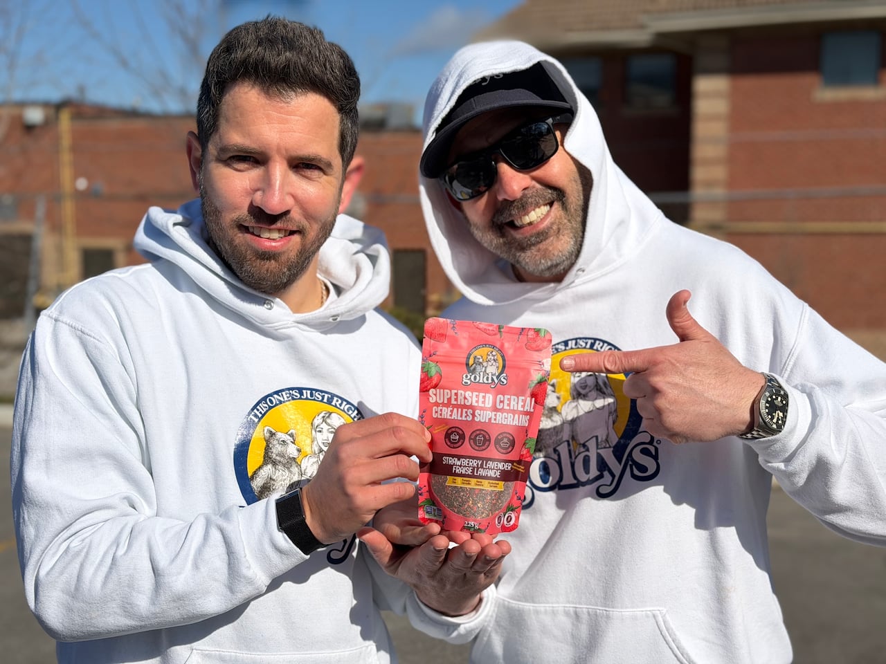 Two men point at a bag of cereal