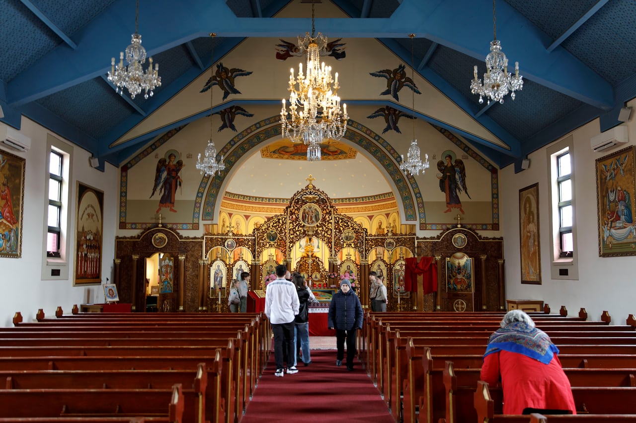 Worshippers inside a church near the main altar.