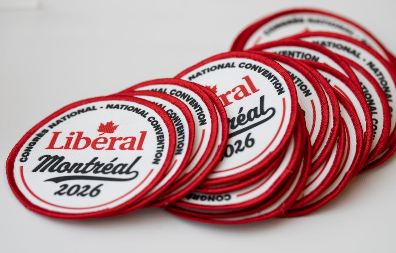 Patches that say Liberal Montreal 2026 are seen on a table.