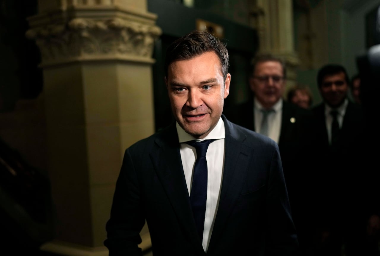 A man stands in a hall.