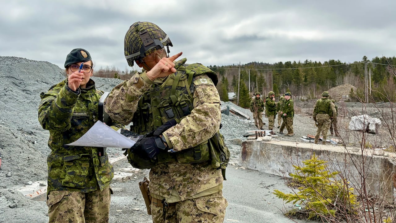 Two people wearing military uniform