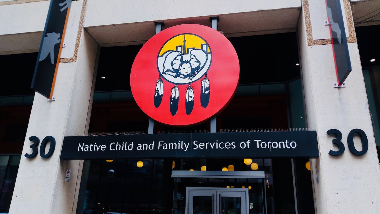 A sign on a building reads Native Child and Family Services of Toronto.