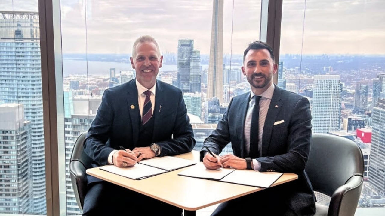 Two men sit at a table.
