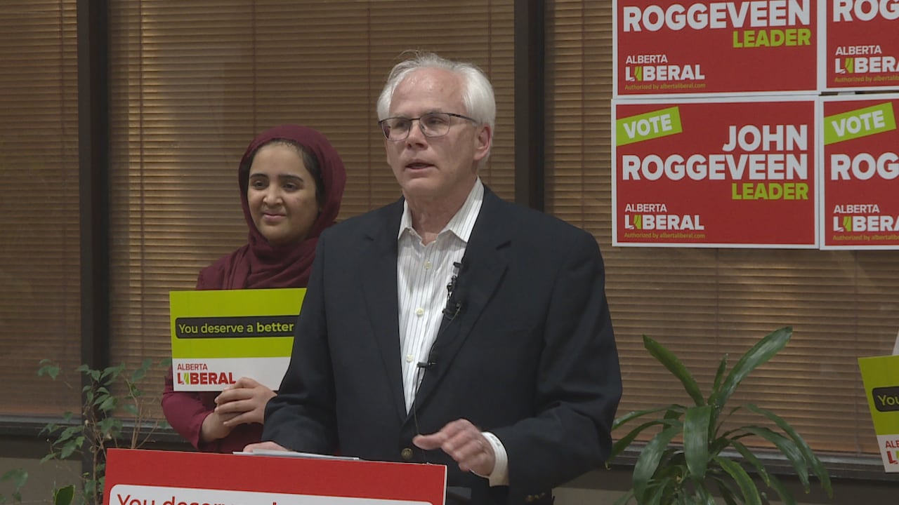 A man stands in front of a podium.