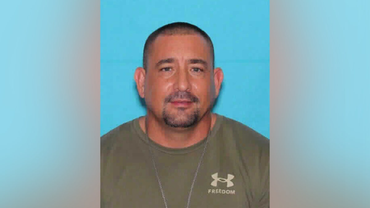 Steven Garcia walking away from his Albuquerque home carrying a handgun