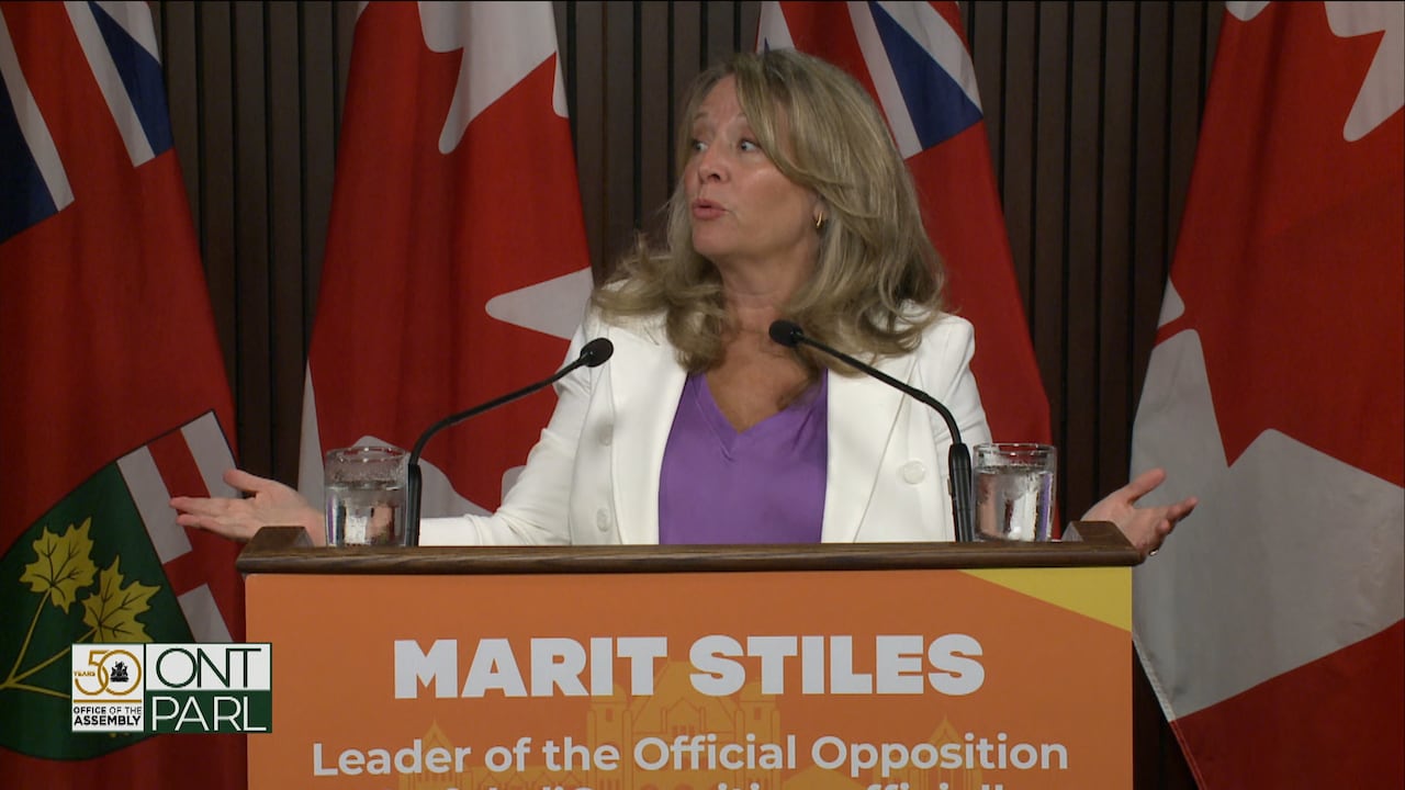 Woman stands at podium