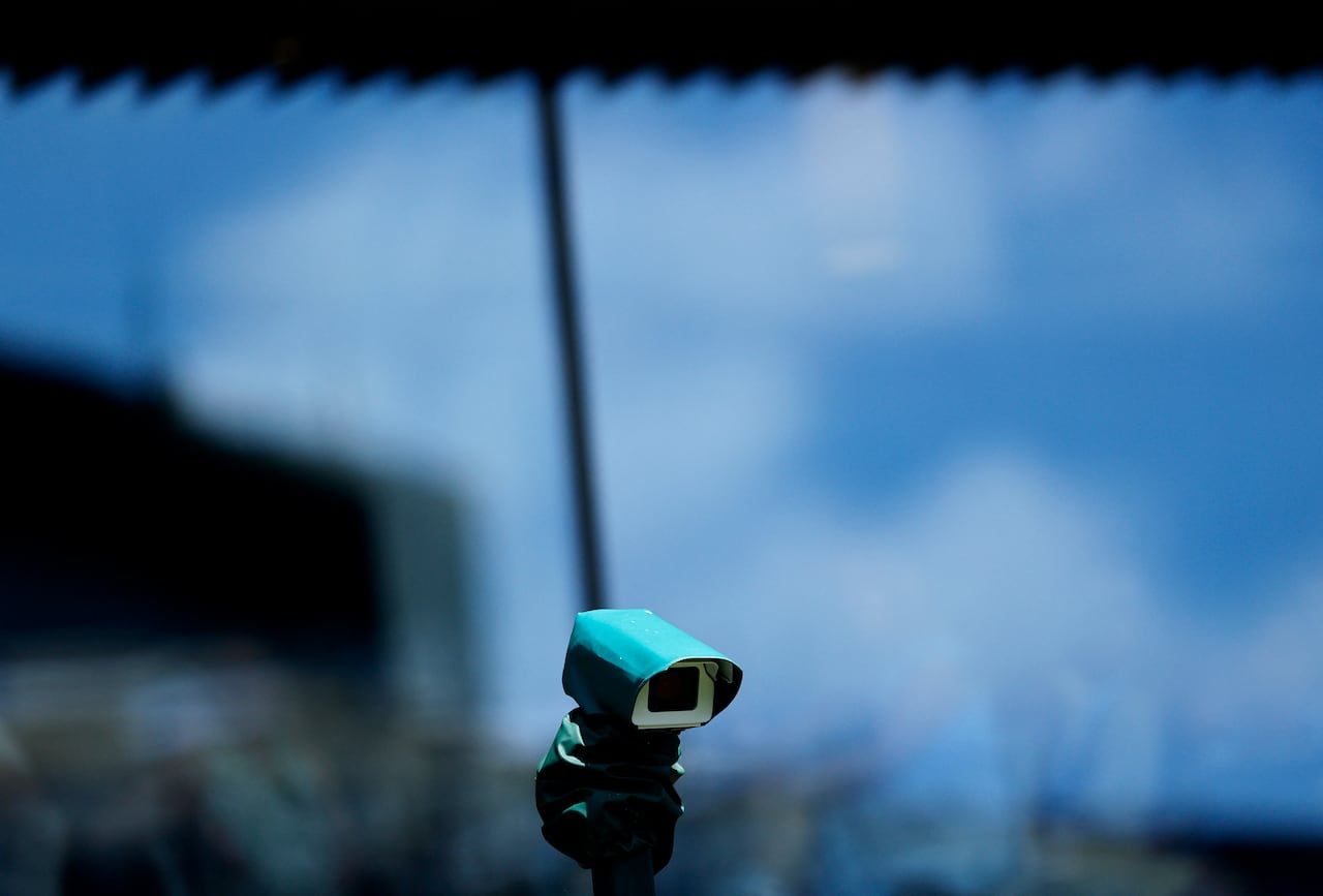 A small camera is seen propped up on a court