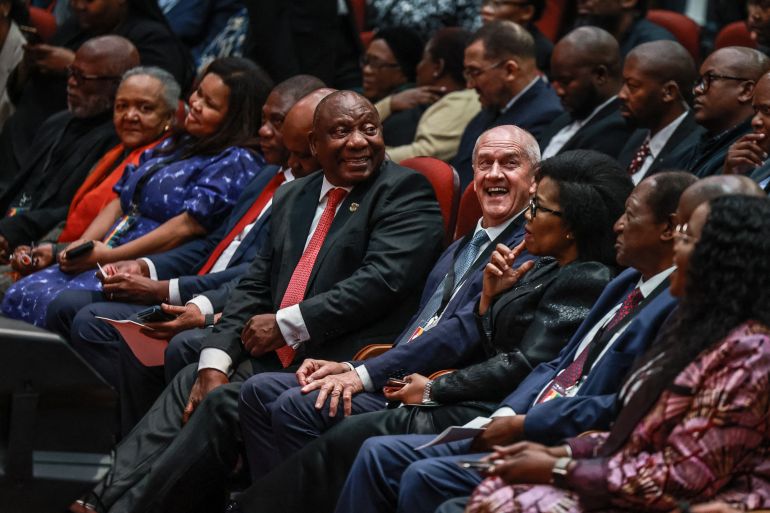 South African President Cyril Ramaphosa (CL) and Former Minister and constitutional negotiator Roelf Meyer (CR) looks at attendees during the first National Convention at the University of South Africa (UNISA) in Pretoria on August 15, 2025. The first National Convention marks the start of the National Dialogue (a chance where all South Africans come together to discuss the country's challenges) at local meetings, national discussions and public platforms aimed at shaping a better future for the next thirty years. (Photo by Phill Magakoe / AFP)
