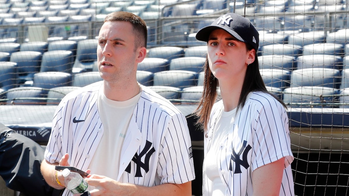 Caitlin Clark and Connor McCaffery seated at Yankee Stadium during a baseball game