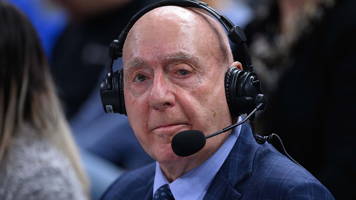Dick Vitale standing on the sidelines during a college basketball game at Gainbridge Fieldhouse