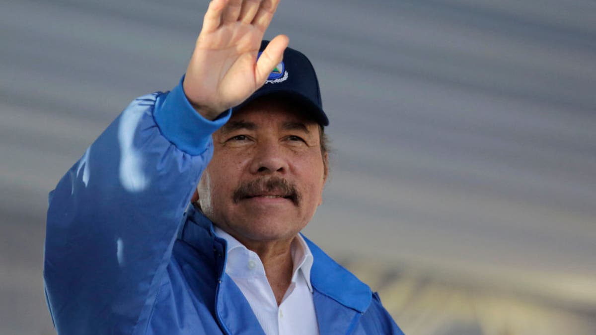 Nicaraguan President Daniel Ortega waving to supporters at a rally in Managua