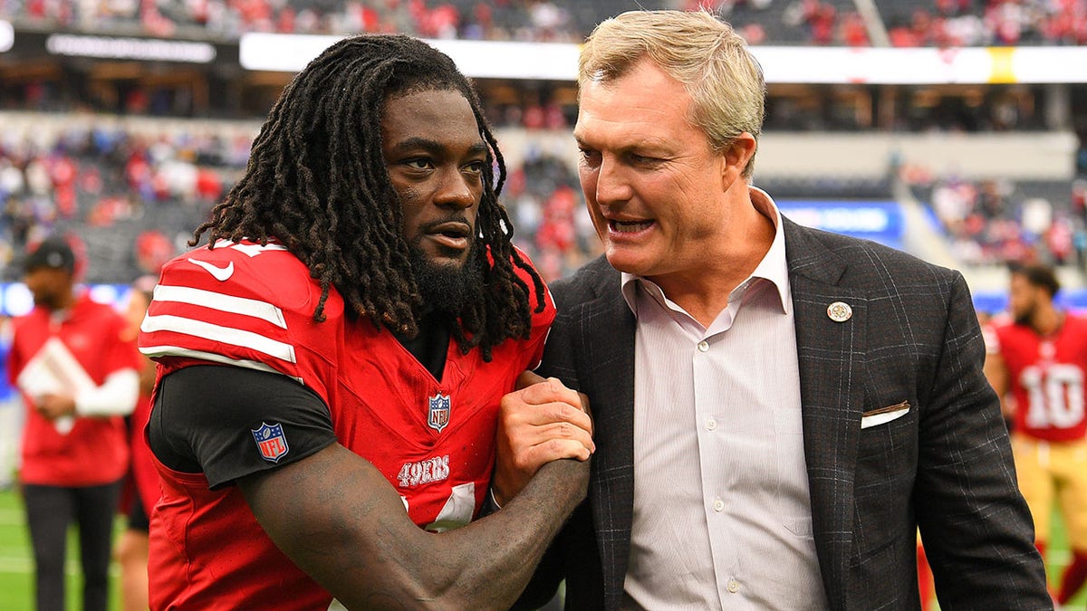 San Francisco 49ers wide receiver Brandon Aiyuk celebrating with general manager John Lynch at SoFi Stadium