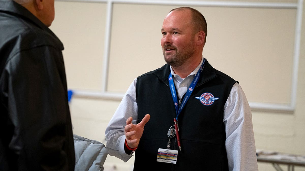 chris hall speaks to volunteer at RAM clinic