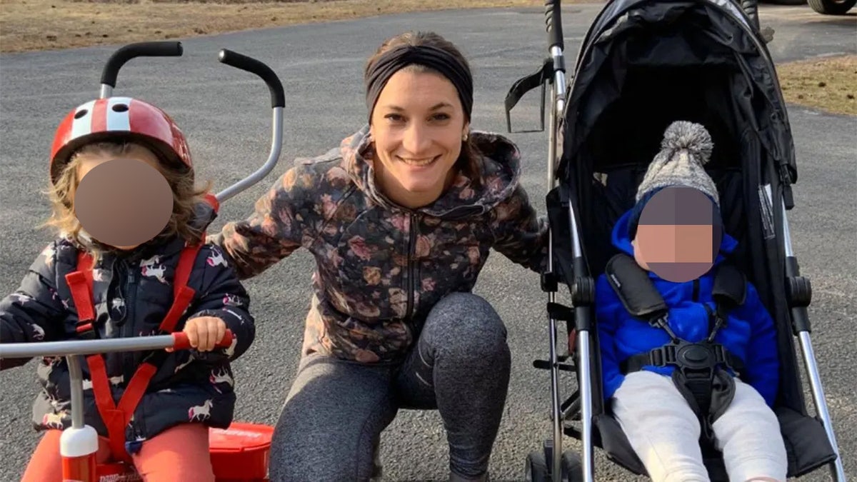 Lindsay Clancy standing with two of their children
