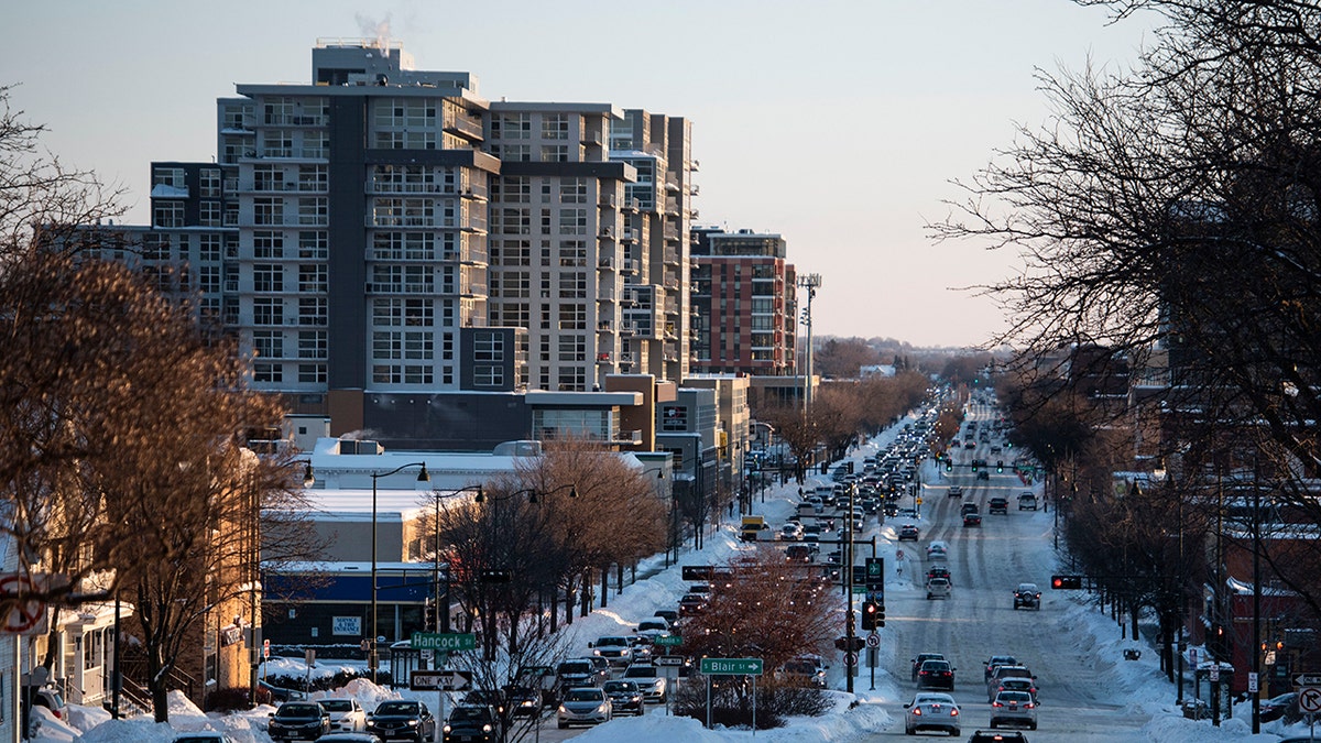 Downtown madison wisconsin street with snow banks and cars driving