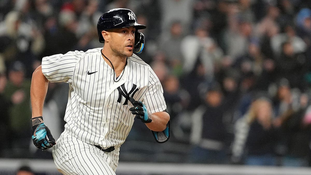 New York Yankees designated hitter Giancarlo Stanton running during a baseball game at Yankee Stadium